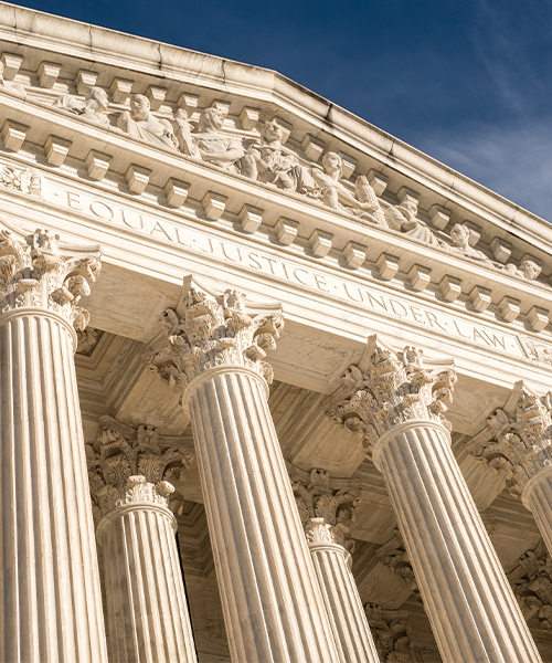 The building features classical columns and a pediment inscribed with